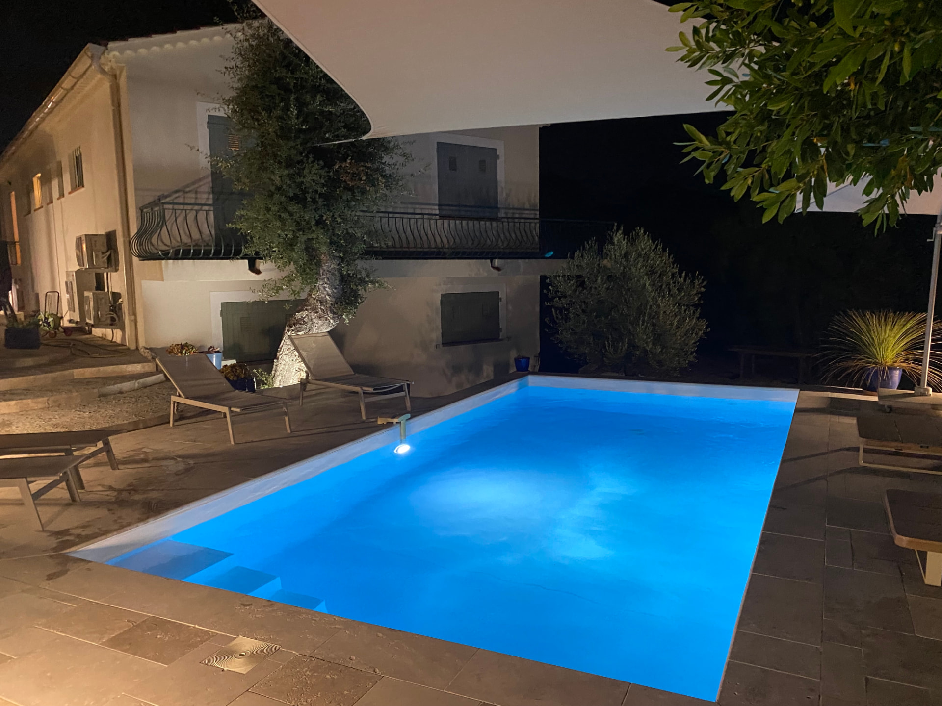 Heated pool at Villa Ricolette glowing at night